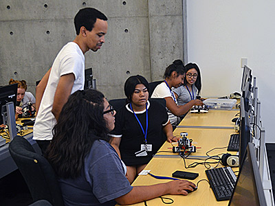 Graduate student Lorenzo Booth teaches a robotics workshop during the Upward Bound Academy this summer.
