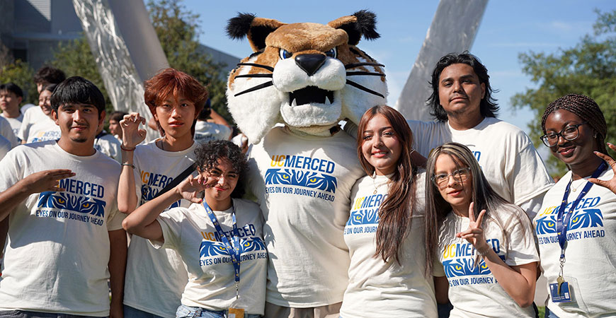 UC Merced students and Rufus mascot at Beginnings sculpture during Scholars Bridge Crossing