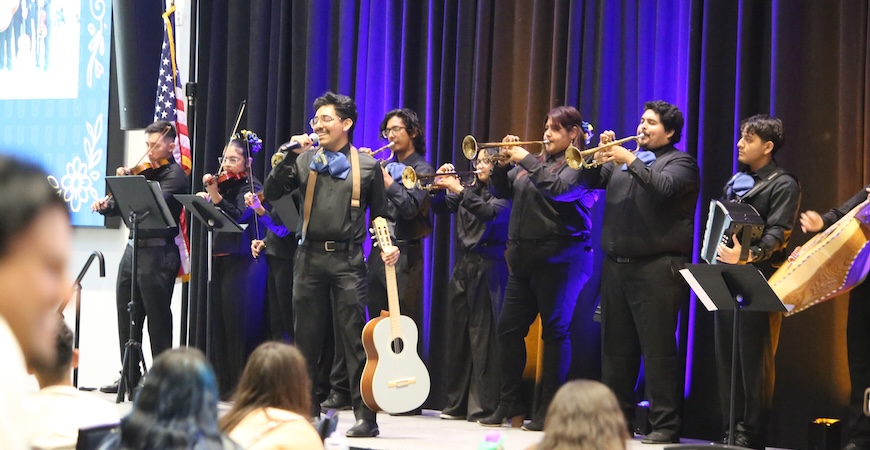 Students dressed in black shirts and pants perform mariachi music in the UC Merced Conference Center.