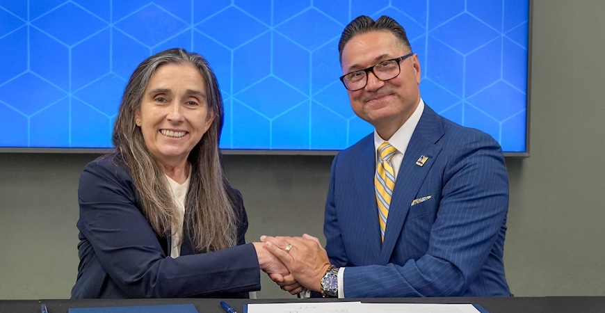 Depicted are lab Director Kim Budil and UC Merced Chancellor Juan Sánchez Muñoz shaking hands at a desk.