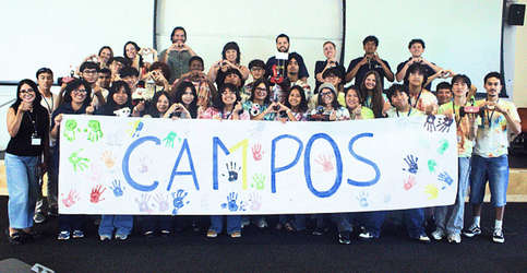 Summer Bridge Academy students pose in front of banner that says Campos