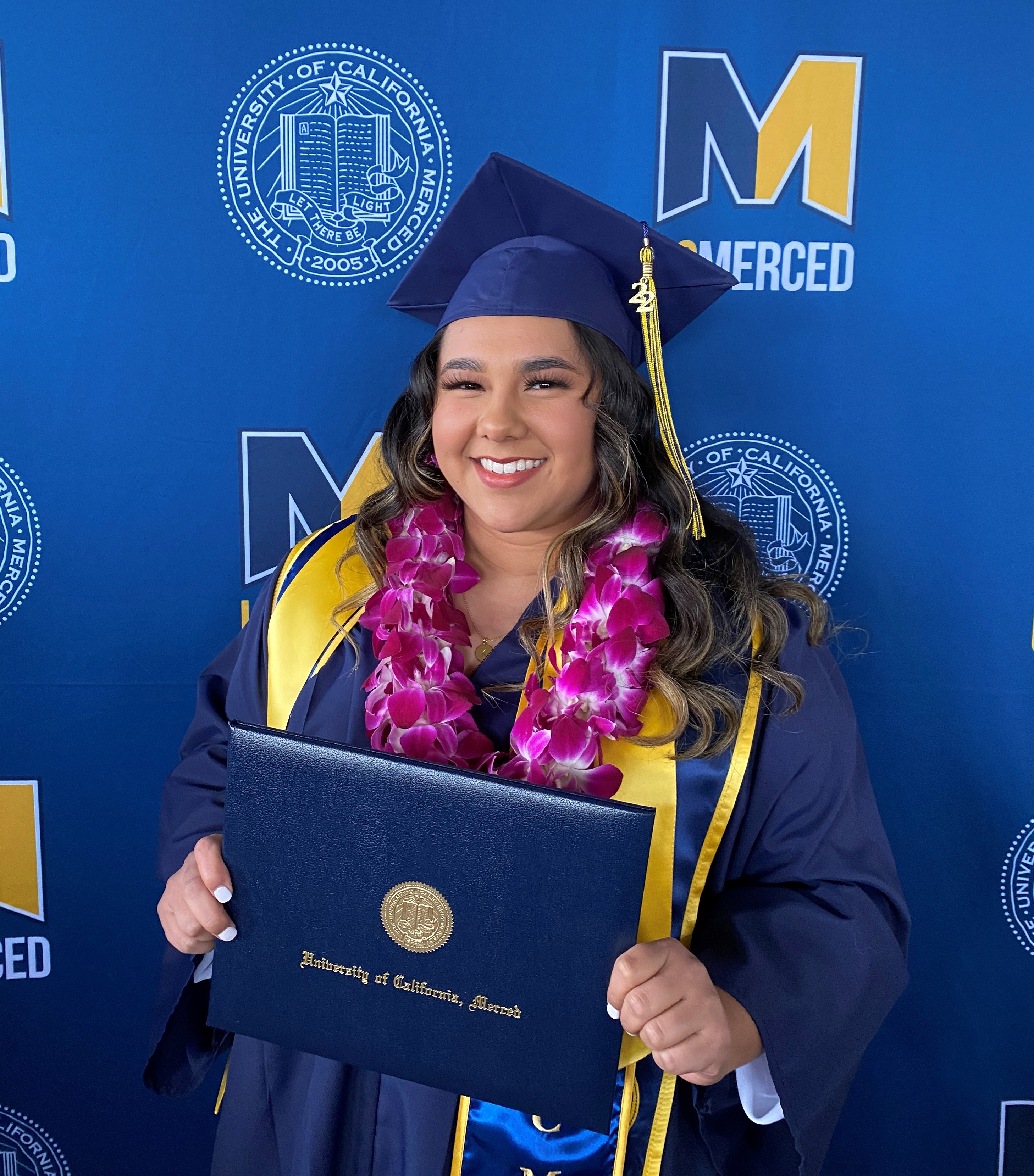 Korynn Maravilla poses with her regalia during fall commencement.