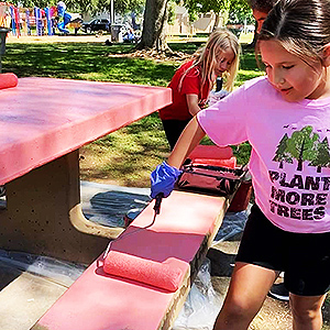 Adison Martinez and members of the Merced Fireflies Camp Fire painted two park benches.