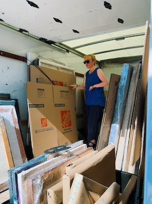 Professor Tonya Lopez-Craig loads art onto a moving truck. 