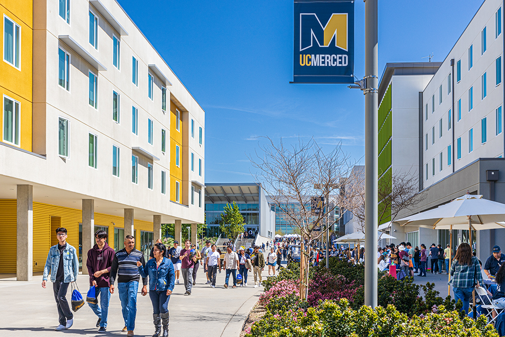 People are seen on Academic Walk during UC Merced's Bobcat Day.