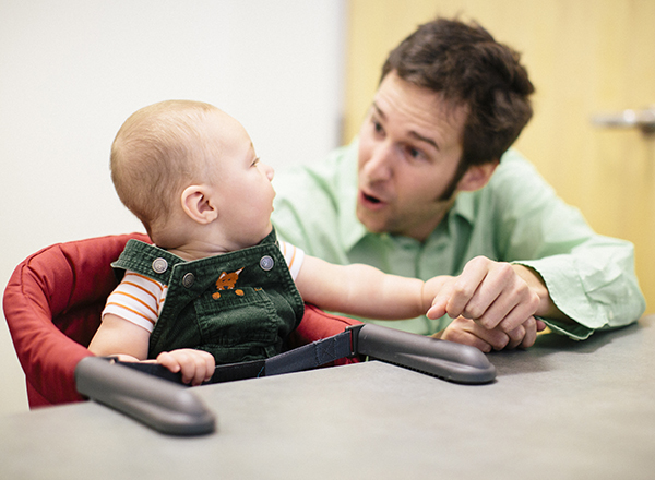 Eric Walle interacts with an infant in the lab.