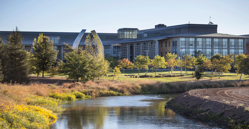 A view of UC Merced's Science and Engineering Buildings with the Beginnings Sculpture to the left.