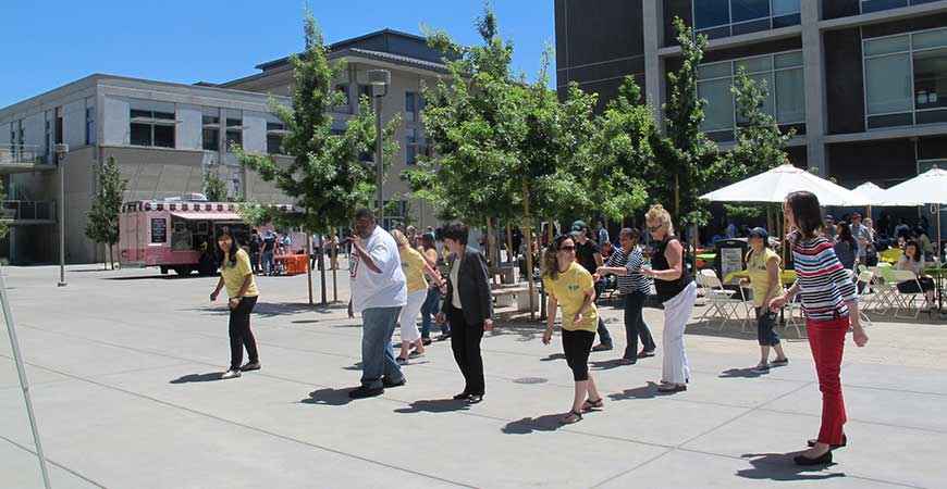 Staff members do the Electric Slide during last year's Staff Appreciation Week picnic.