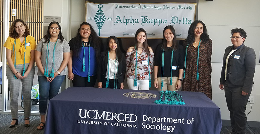 Graduating seniors receive their Alpha Kappa Delta cords for graduation at the symposium. From left to right: Valezka Murillo, Karen Gomez, Lesly Castro, Keila Luna, Rocío Murillo, Anne Oyales, Ellie Robledo, and Professor Sharla Alegria