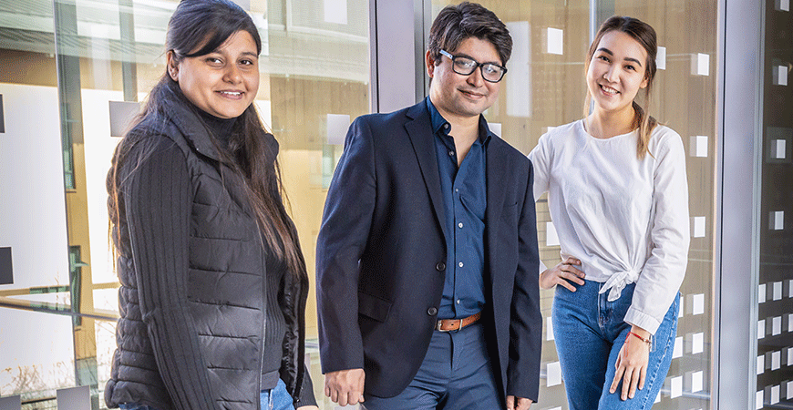 Computer science Professor Ahmed Arif stands with two of his female graduate students in the Science and Engineering 2 Building.