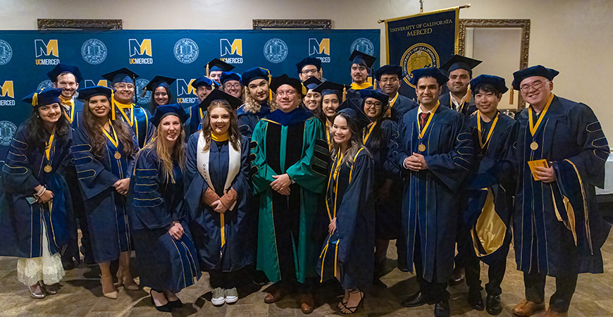 Graduates pose for a photo.