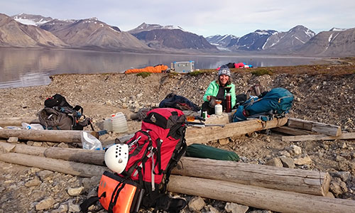Professor Marilyn Fogel makes coffee on the shores of Billefjorden, Svalbard, nearby the Ebbadalen “blueberry” rock outcrop.