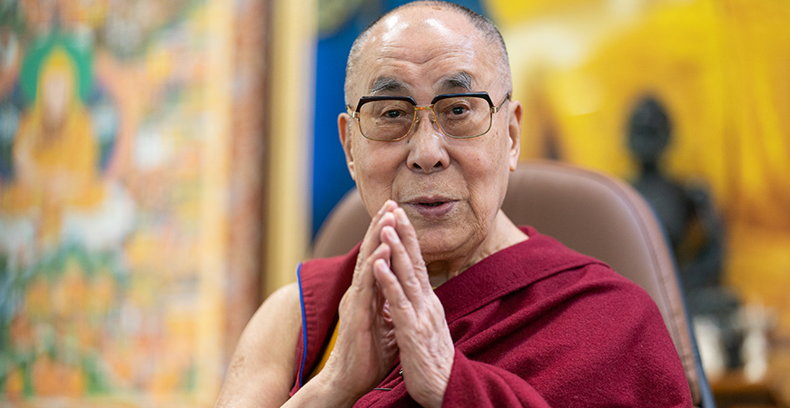 The Dalai Lama is seen with his hands together.