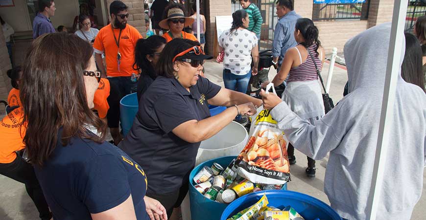 UC Merced volunteers collect food donations during the 2017 We Care Wednesday Community Food Drive at the Merced County Fair. The goal is to collect 10,000 pounds of food.
