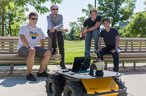 Professor Stefano Carpin, second from left, and his students show off their new robot.