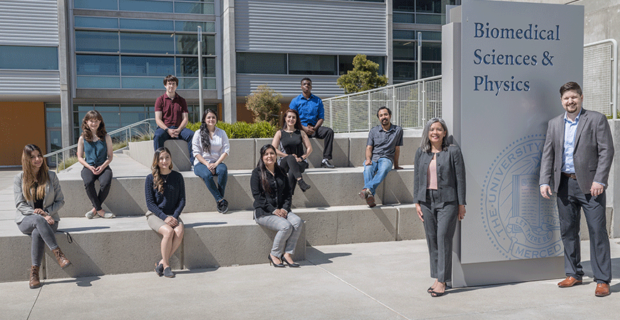 The Manilay and Spencer lab groups sit together on campus.