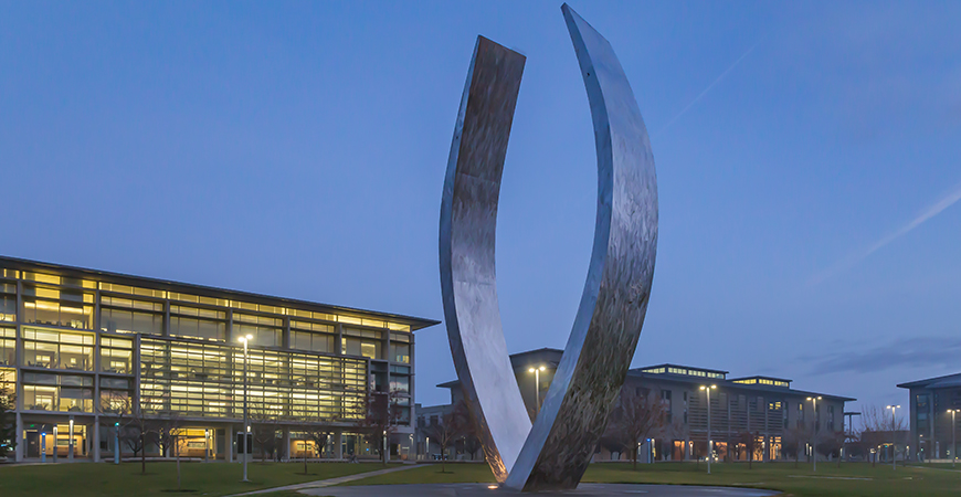 An image of UC Merced's Beginnings sculpture at night