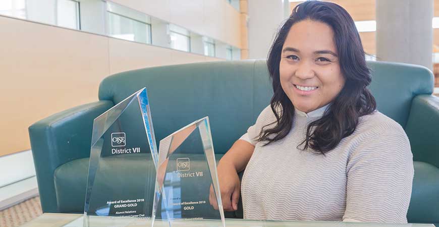 Jessica "JaeJae" Julian ('10) poses with two awards from District VII of the Council for Advancement and Support of Education.