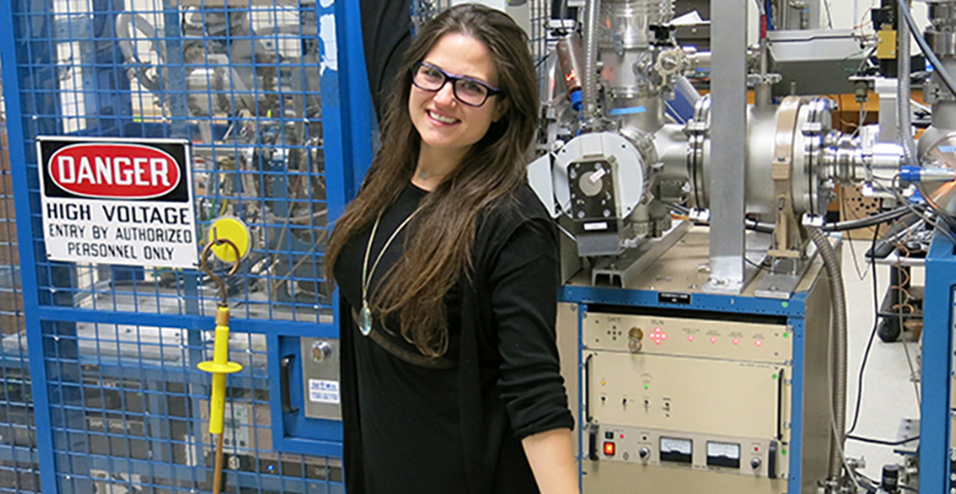 Kimber Moreland with the accelerator mass spectrometry (AMS) instrument. Photo courtesy of Lawrence Livermore National Lab: LLNL-PHOTO-769483.