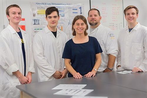Professor Ashlie Martini, front, and her lab group, from left to right, undergraduate students Carter Brown and Nicholas Walters, graduate Student Sean Lantz and undergraduate student Cory Mercer, have a partnership with Chevron.