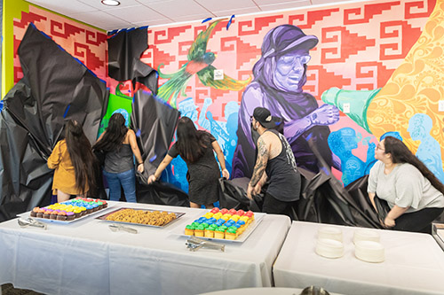 Students unveiled a mural that represents the university's past, present and future at the opening ceremony for the Multicultural Center.