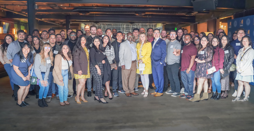 UC Merced alumni and campus leaders pose for a photo at M!X Downtown in Sacramento.