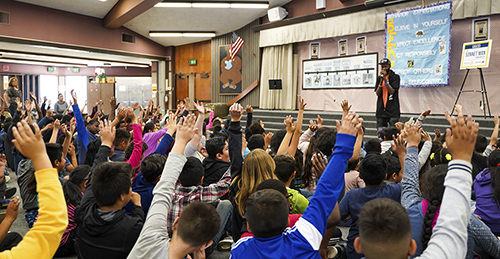 Students interact with The Sonnet Man at Gracey Elementary School in Merced.