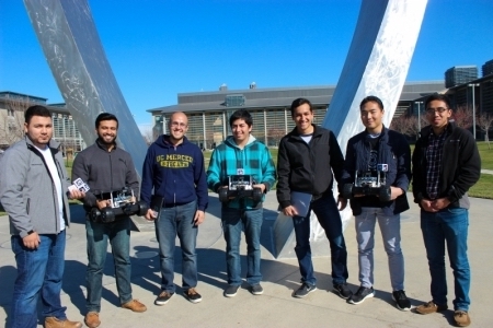UC Merced's NASA Swarmathon team poses in front of campus's Beginnings sculpture.