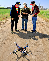 Graduate student Tiebiao Zhao, center, and other students work on precision agriculture projects.