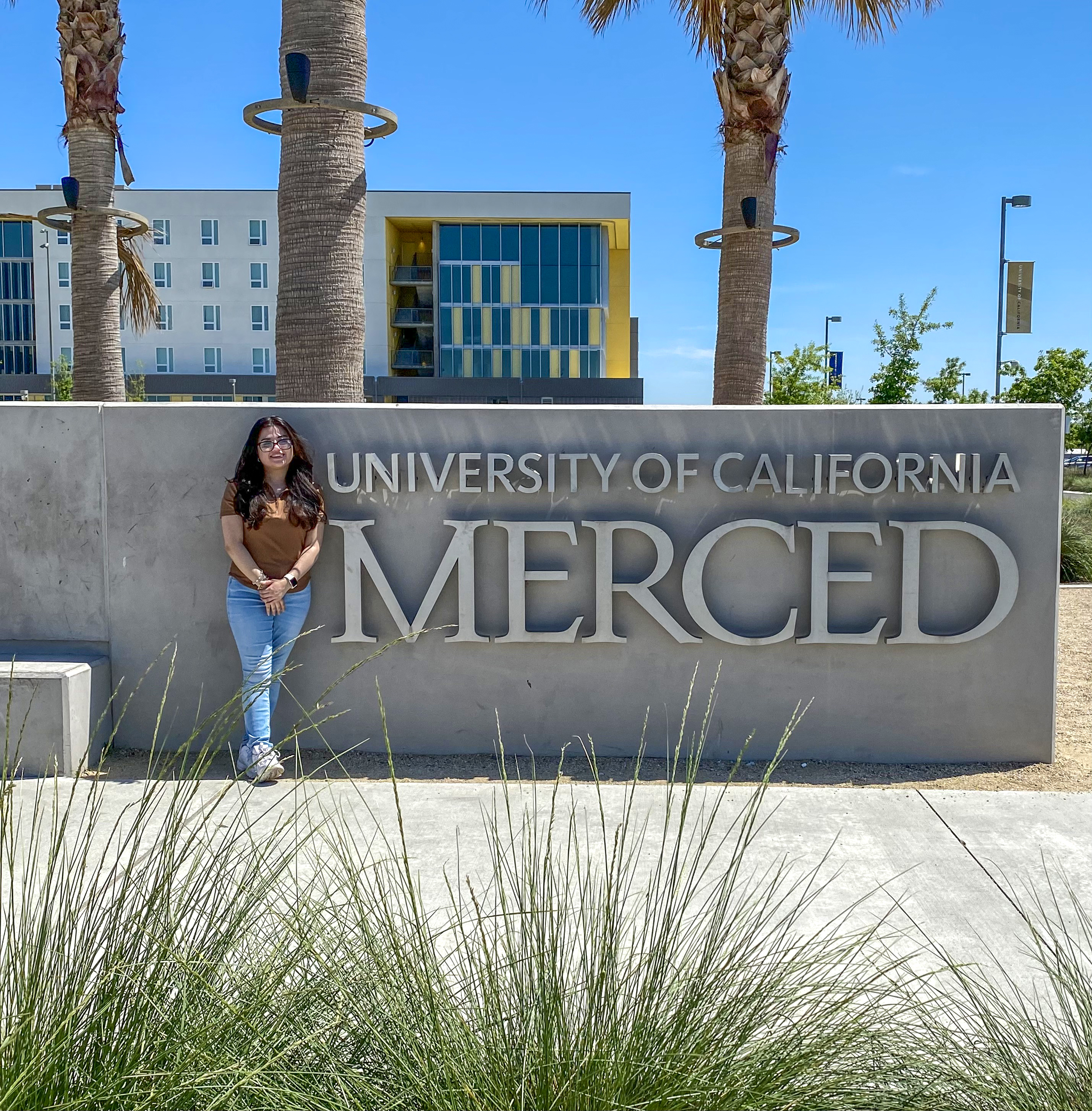 Genesis Iñiguez takes a photograph at UC Merced.