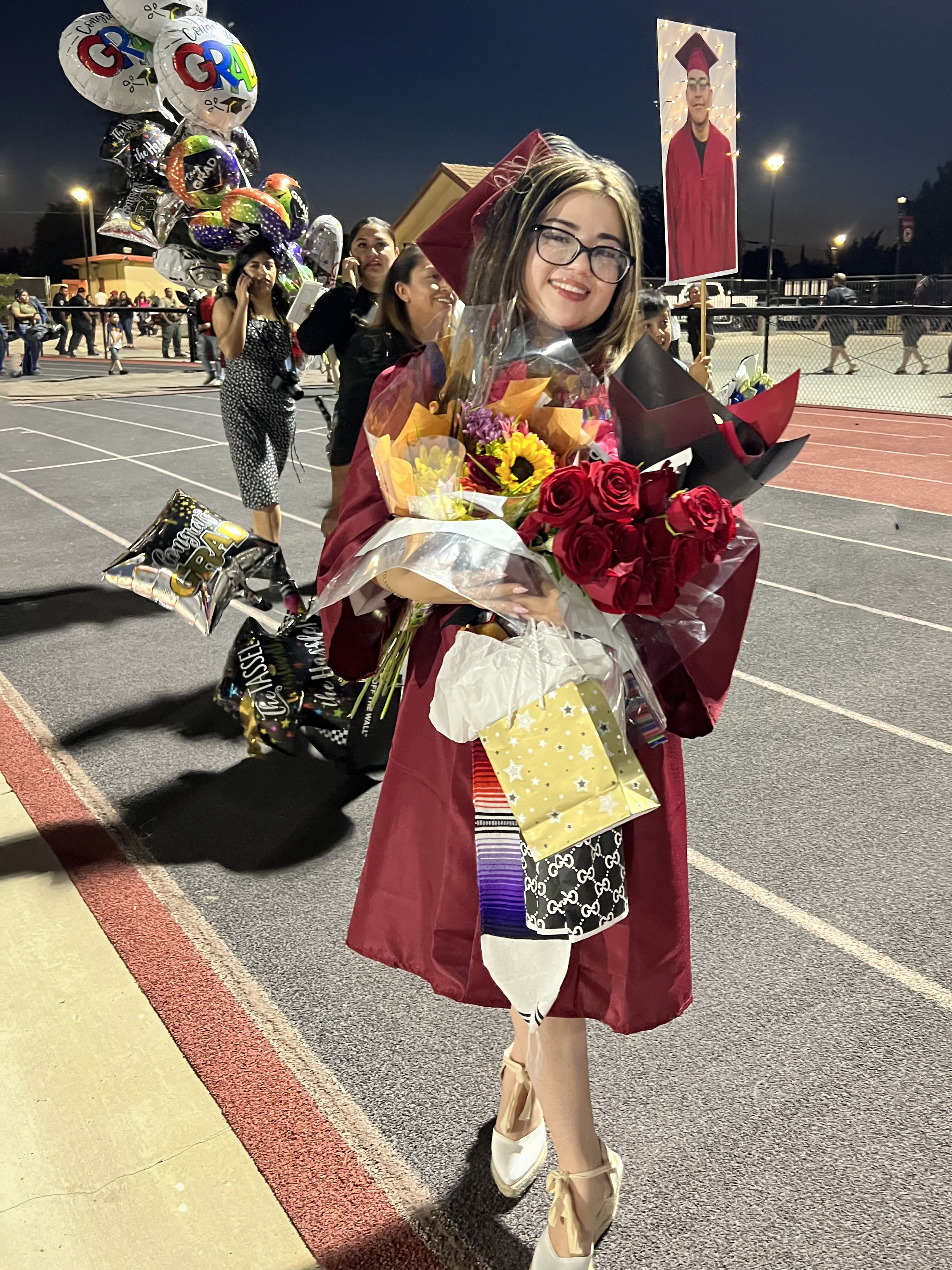Genesis Iñiguez poses for a photo after graduating from Orosi High School.