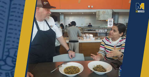 Two people and Nowruz dishes for UC Merced lunch event